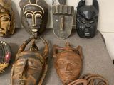 many different types of african masks on a table