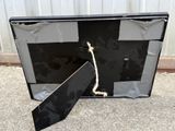 a picture of a black suitcase with a tie on it