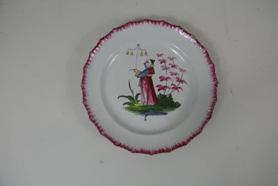 une assiette avec l'image d'une femme et d'un oiseau