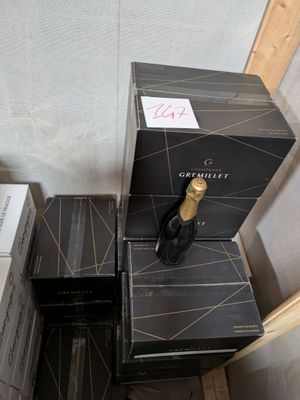 boxes of wine are stacked on top of each other in a room