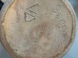 a close up of a vase with a number on it