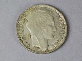 a close up of a silver coin with a woman ' s head on it