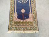 an oriental rug with a blue background and a gold border