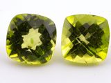 a pair of green quartzite gems on a white surface