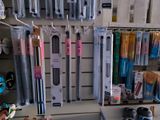 many different types of toothbrushes hanging on the wall