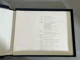 an open book with a poem in it sitting on a table