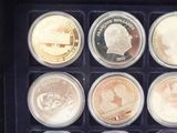 six different coins in a black box with a black lid