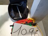 a bag of wires and a digital meter on a table