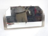 a man standing in front of a mirror holding an umbrella