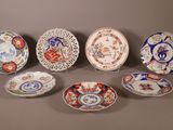 six assiettes présentant différents motifs et dessins, disposées sur une table