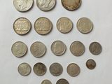 a close up of a bunch of coins on a white surface