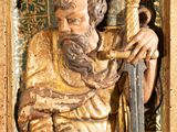 a statue of a man holding a sword and a sword in his hand