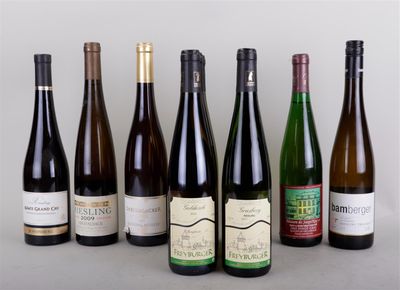 several bottles of wine are lined up in a row on a table