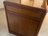 a wooden desk with a glass top in a room