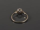 a close up of a diamond ring on a black surface
