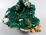 macro shot of a cluster of green and white crystals on a white surface