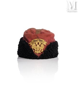 a red and black hat with a gold emblem on it