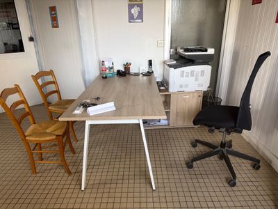 a desk with a chair and a computer on top of it