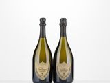 two bottles of champagne sitting on top of a table