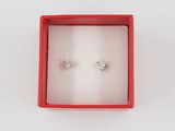 pair of diamond earrings in a red box on a white surface
