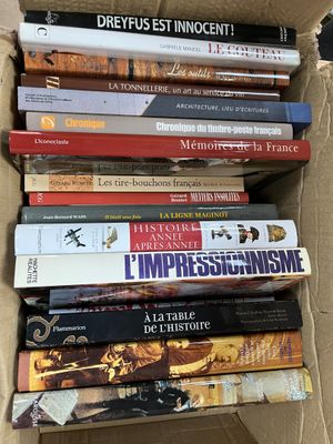 many books in a cardboard box on a table