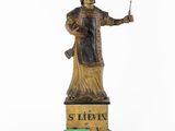 an old statue of a man holding a knife and fork