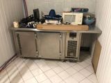 a small kitchen with a microwave and other appliances on the counter
