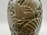 a vase with a bird on it on a white background