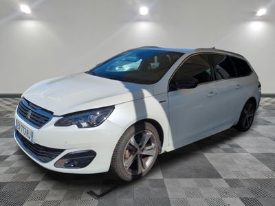 the white car is parked on a checkered floor in the garage