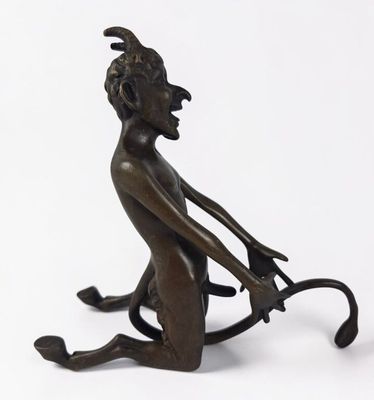 an image of a bronze statue of a monkey sitting on its hind legs