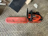 a chainsaw that is sitting on the ground