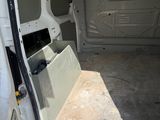 a white van with the door open and the seat down