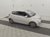 a picture of a small white car parked in a garage