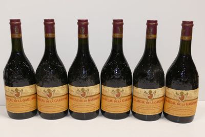 six bottles of wine are lined up in a row on a table