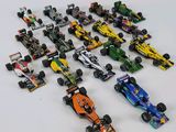 a lot of toy race cars on a white surface