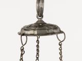a close up of a metal object with chains hanging from it ' s sides