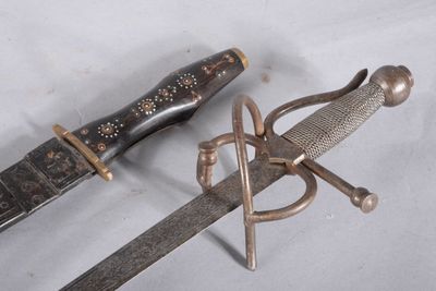 two different types of swords on a white surface