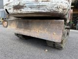a close up of a rusted old boat on a trailer