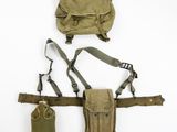 an assortment of military items including a backpack, belt and pouch