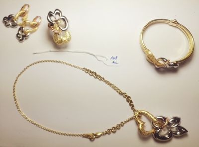 a necklace, bracelet, and ring laying on a table
