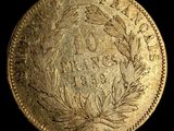 a close up of a gold coin on a black background