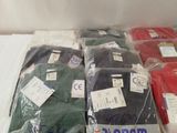 several pairs of plain t - shirts in plastic bags on a table