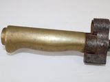 an old brass pipe with a metal handle on a white surface