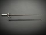 a pair of swords on a gray background