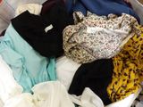 a basket full of clothes that is sitting on the floor