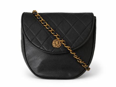 a black leather shoulder bag with a gold chain