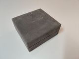 gray box on a white table with a white background