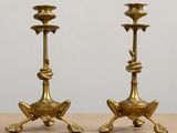 pair of antique brass candlesticks on a wooden table