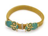 an image of a gold and turquoise bracelet with two fish on it