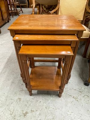 deux tables gigognes en bois posées à même le sol, à côté d'une chaise